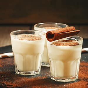 Traditional winter eggnog with milk, rum and cinnamon